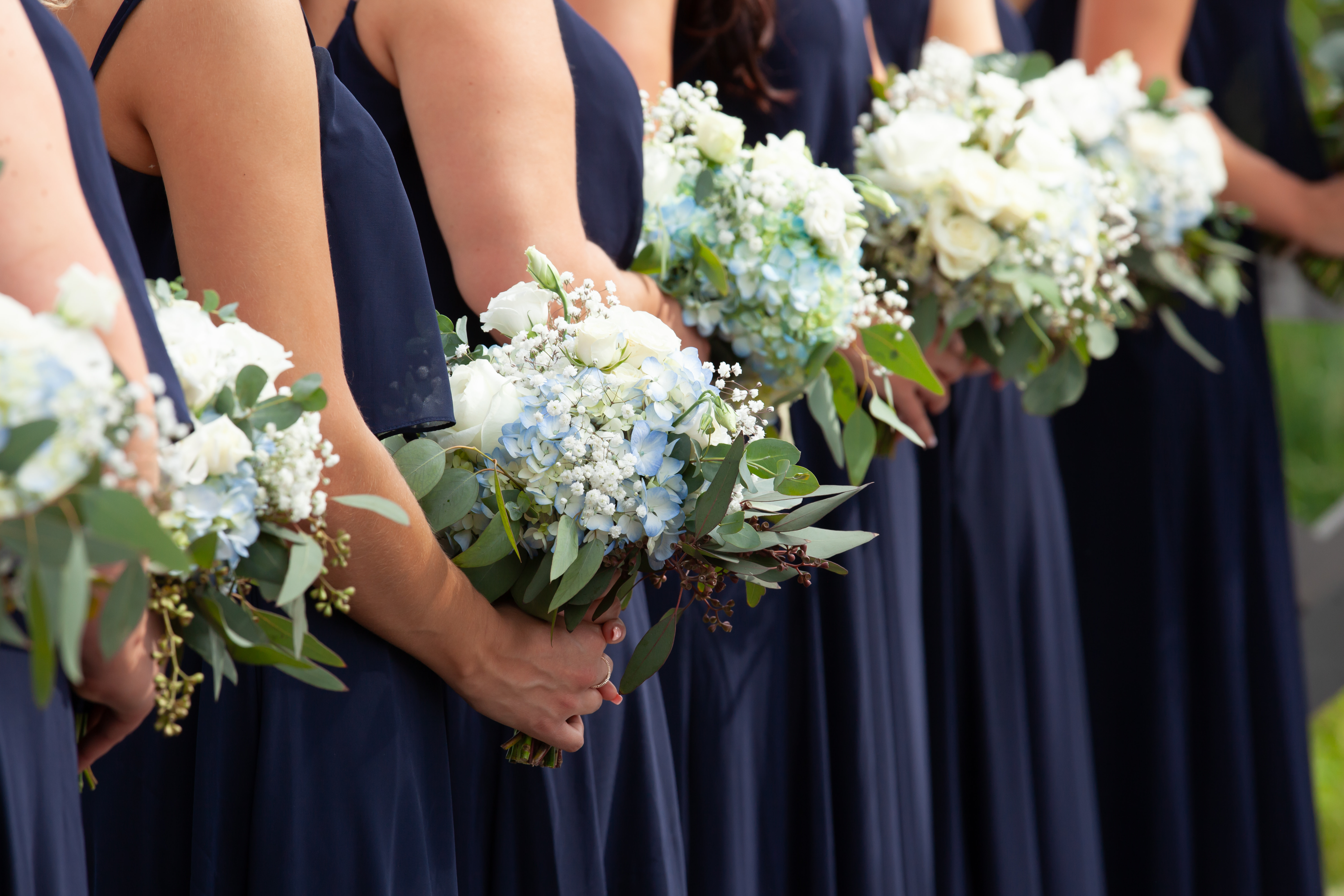 Bride in wedding gown looking out an open doorway